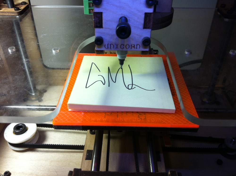 Letters 'GML' drawn graffiti-style on a sticky note inside the Cupcake CNC.