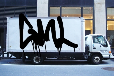Simulated photo of the same 'GML' graffiti rendered on the side of a box truck.