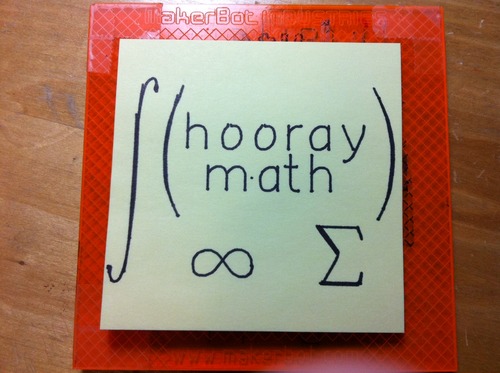 Sticky note with a drawing of the words 'hooray math' framed by math symbols for integral, parenthesis, infinity, and summation.